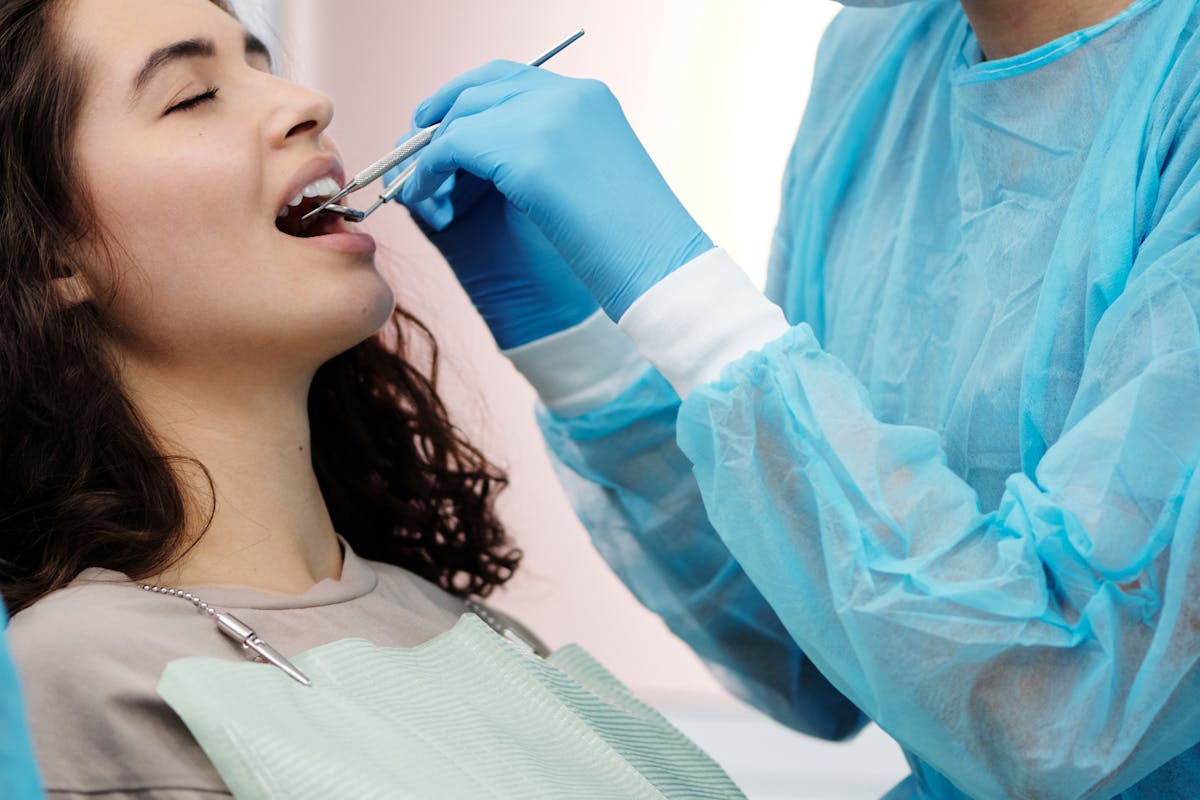 A Dentist Checking the Woman's Teeth