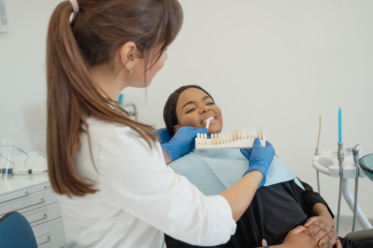 Dentist holding a Tooth Shade Guide