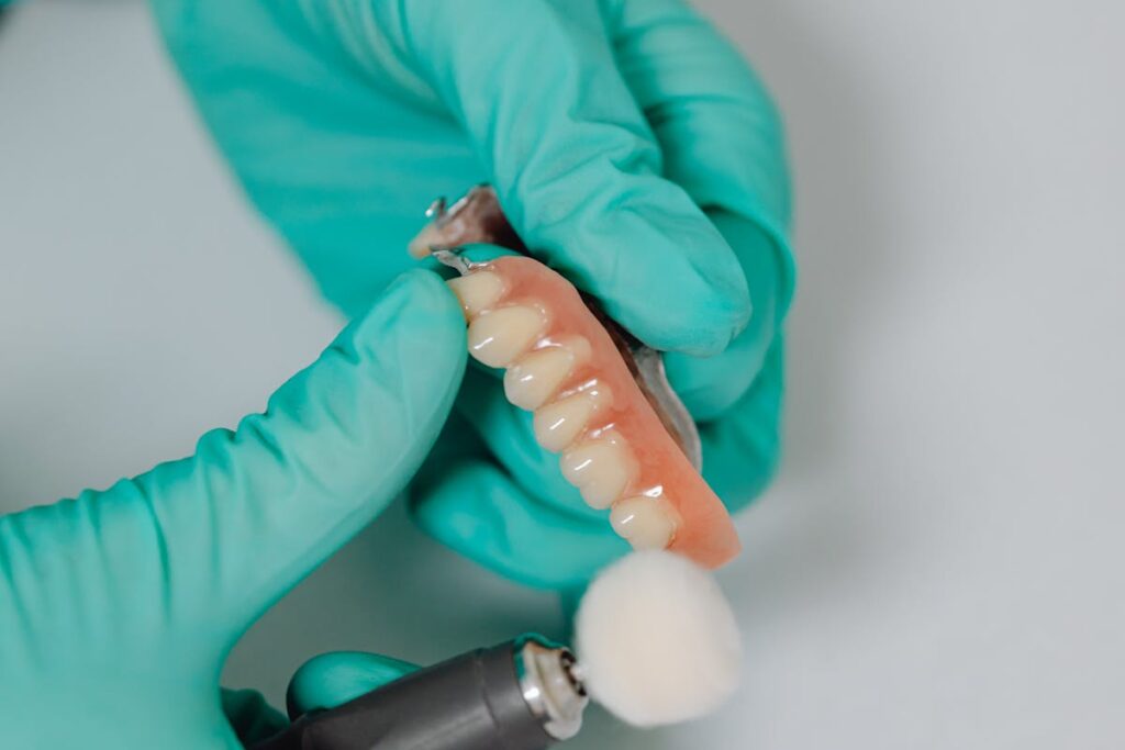 A Close-Up Shot of a Person Polishing a Denture