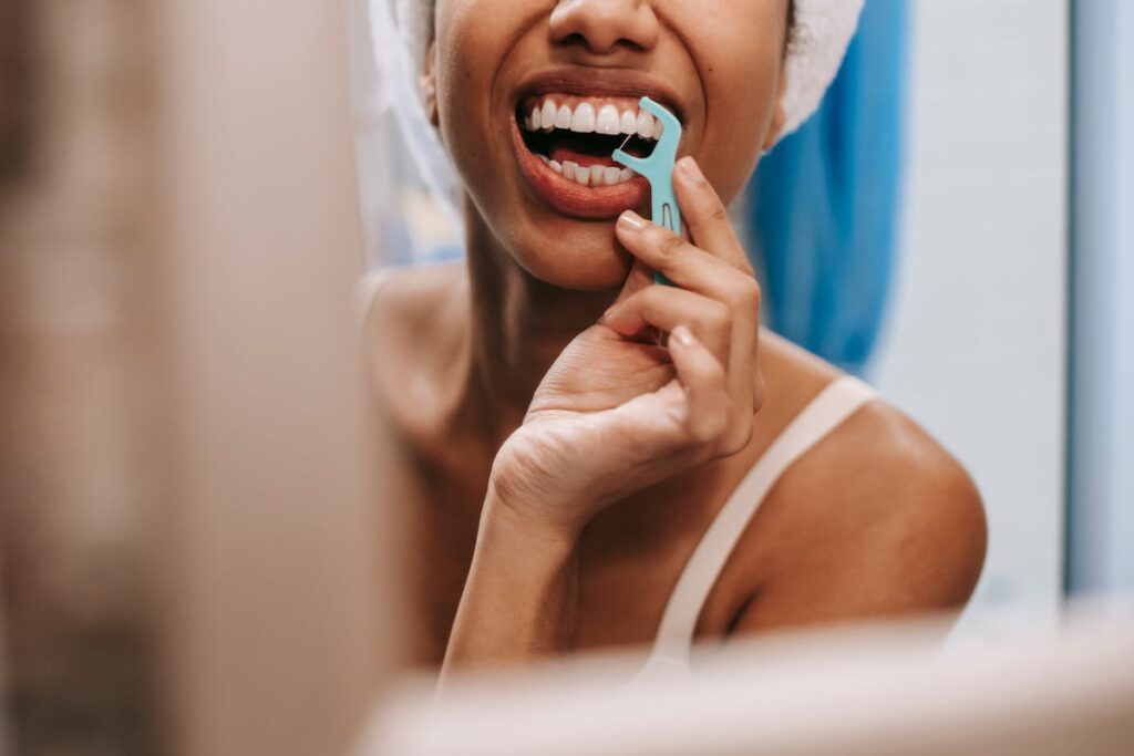 Reflection of woman cleaning teeth