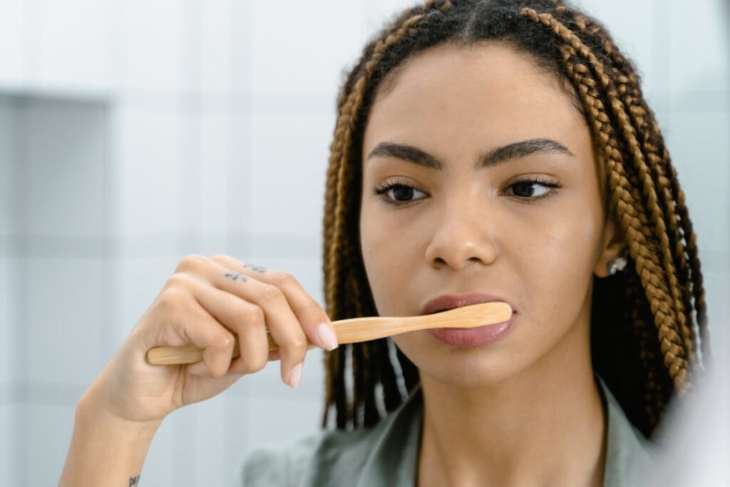 Close Up Photo of Woman Brushing Her Teeth