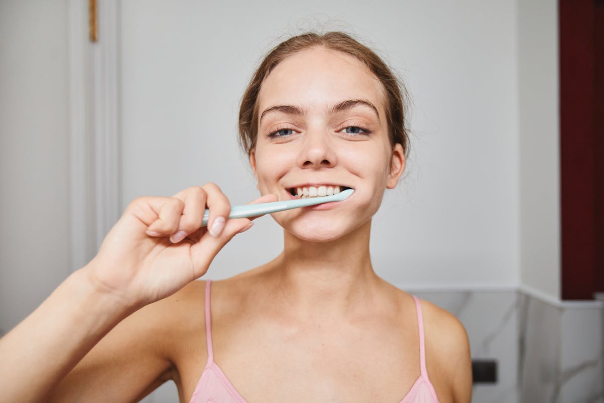 Close-Up Shot of a Woman Brushing Her Teeth