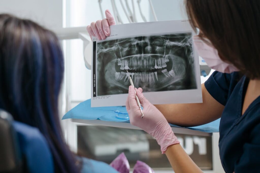 Dentist showing an X-ray Image on a Patient