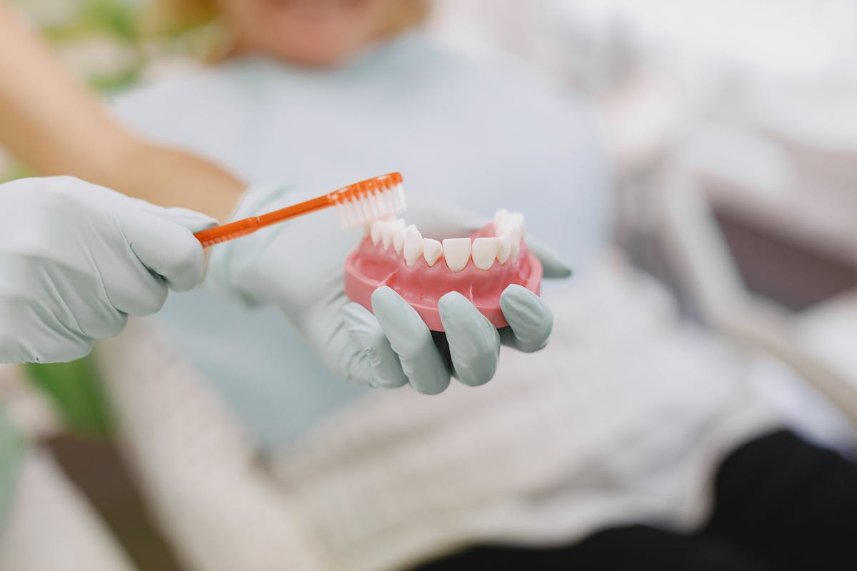 Gloves with Toothbrush over Teeth