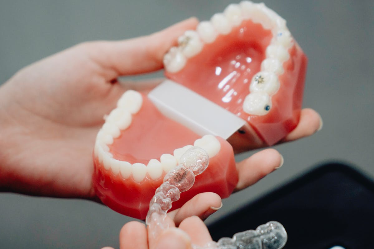 Hands of a Person Holding Clear Retainers