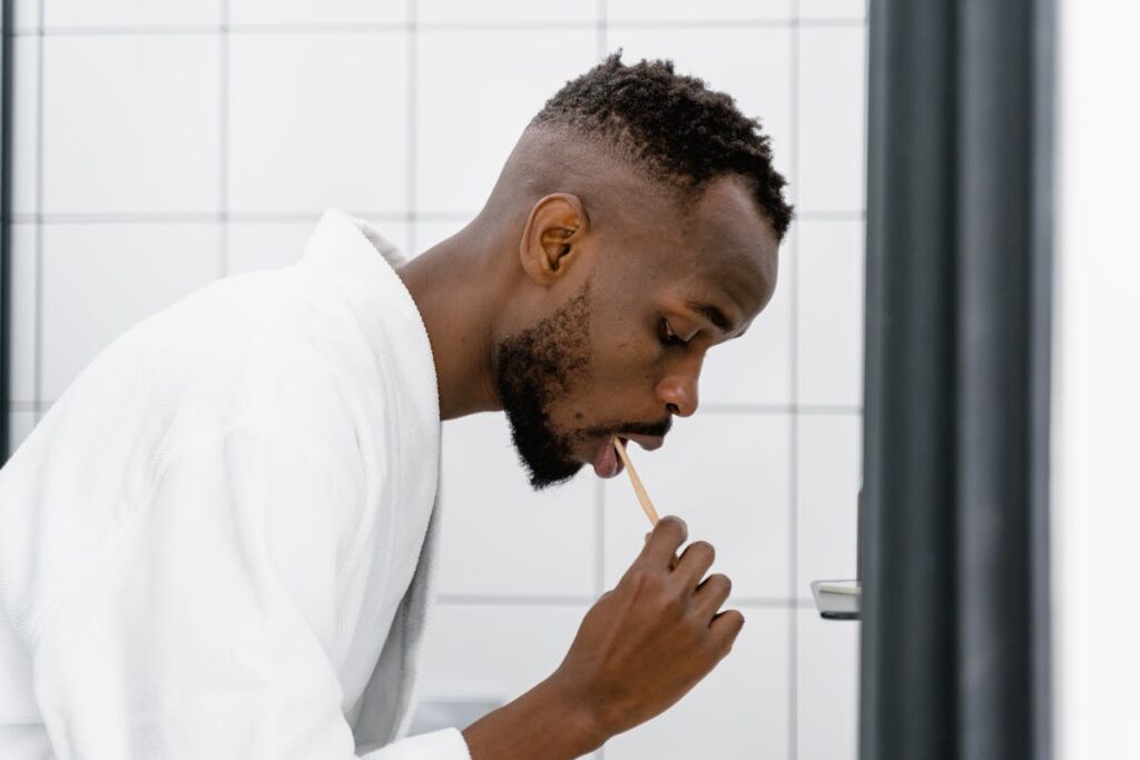 Man in Bath Robe Brushing His Teeth