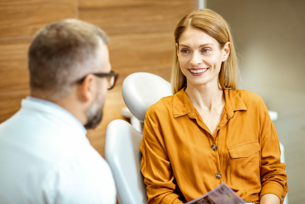 Beautiful adult woman as a patient with senior dentist during a medical consultation at the dental office