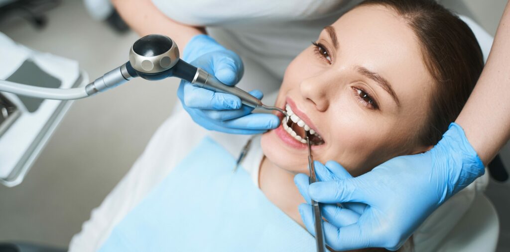 Pretty woman is staying in dental clinic stock photo