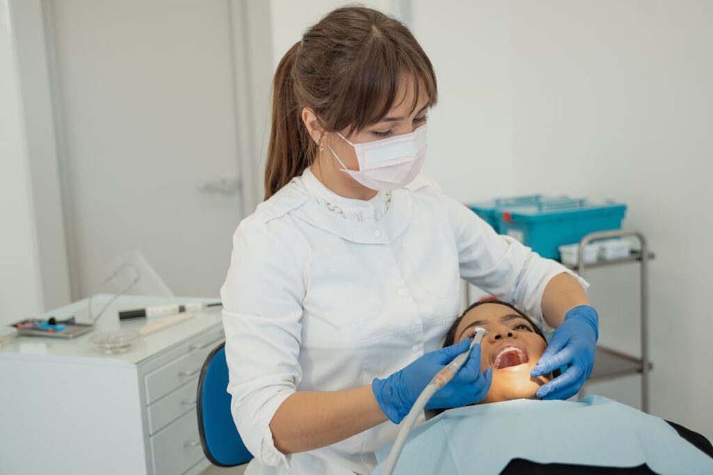 Dentist performing a routine dental check-up on a patient in a modern clinic setting.